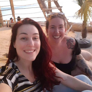A picture with the author and a friend on a beach