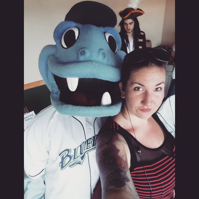 The author with a large blue sports mascot and a pirate in the background