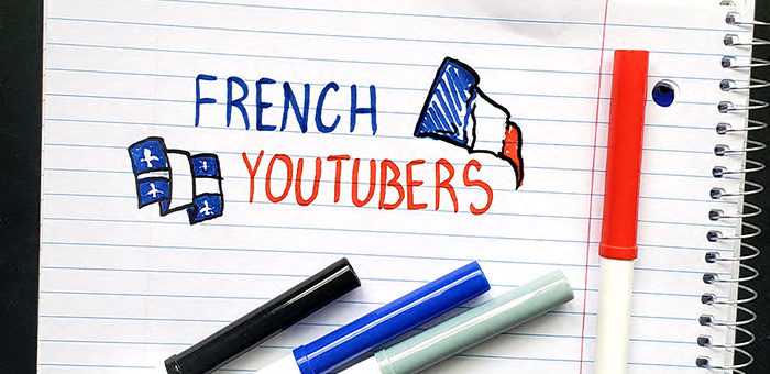 The words "French Youtubers" doodled onto a notebook with markers