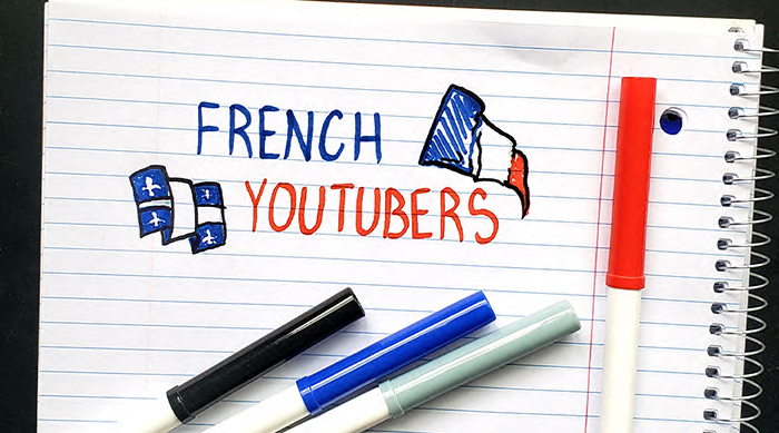 The words "French Youtubers" doodled onto a notebook with markers